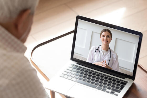 elderly man sit at home having online consultation with doctor on computer