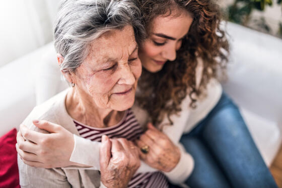 Young woman hugging an older woman